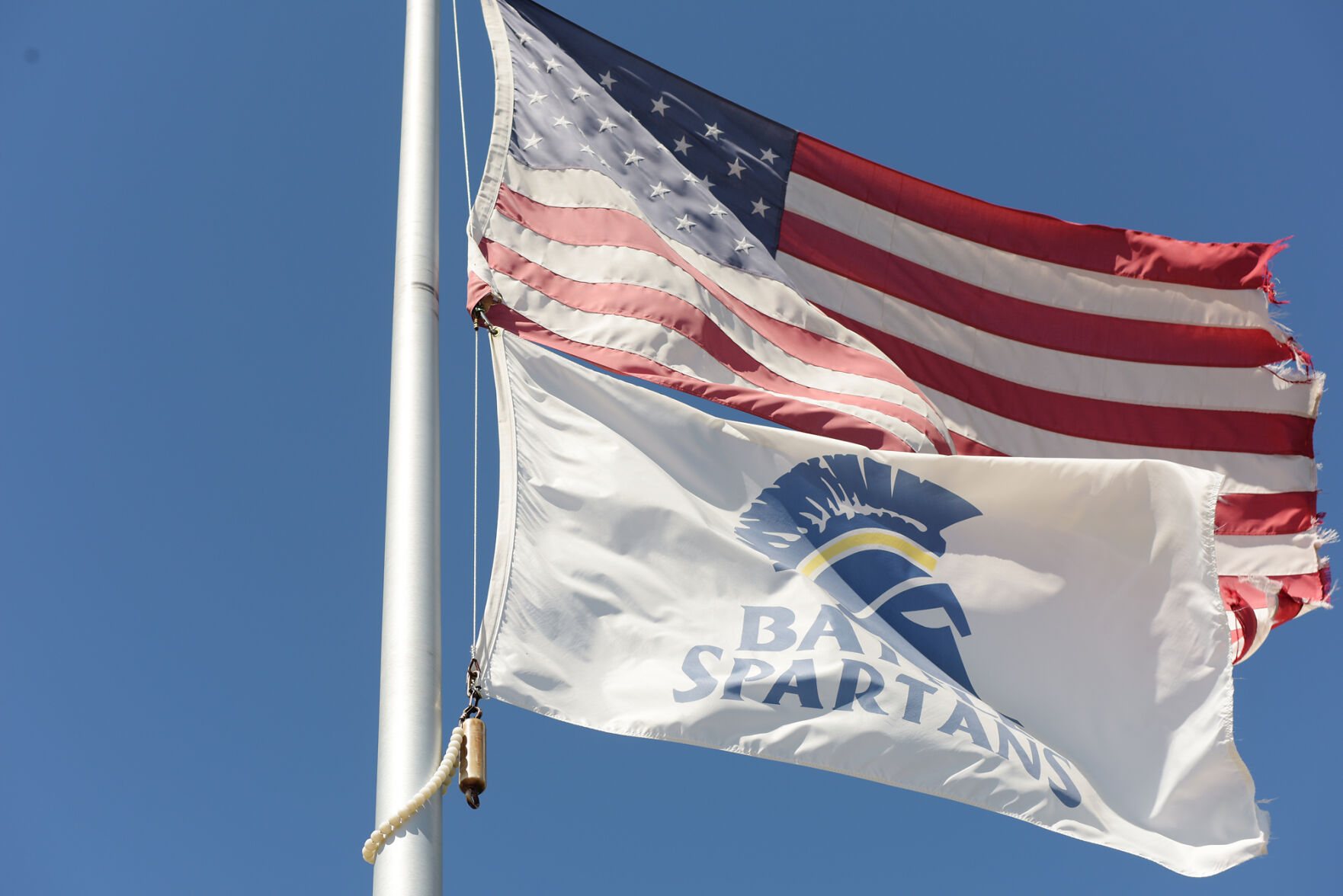 Flags wave in the wind outside of Battle High School